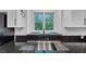 Modern kitchen sink boasts a granite countertop and a large window offering a view of lush greenery at 284 Due West Ct, Dallas, GA 30157