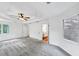 Bright and airy main bedroom boasts plush carpet, tray ceiling with fan, and ensuite bathroom access at 284 Due West Ct, Dallas, GA 30157