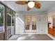 Enclosed porch with ceiling fan and doors leading to backyard and interior at 284 Due West Ct, Dallas, GA 30157
