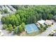 Overhead shot of tennis courts and community pool surrounded by lush trees at 7520 Ledgewood Way, Suwanee, GA 30024