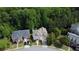 Stunning aerial view of two stately homes nestled among lush, mature trees at 7520 Ledgewood Way, Suwanee, GA 30024