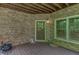 Covered back porch with brick siding, an exterior door and window with natural light at 7520 Ledgewood Way, Suwanee, GA 30024