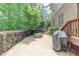 Backyard stone patio with firepit and covered grill area at 7520 Ledgewood Way, Suwanee, GA 30024