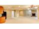 Open basement with fireplace, carpeting, and kitchen area perfect for entertaining at 7520 Ledgewood Way, Suwanee, GA 30024