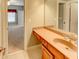 Bathroom with single vanity, granite countertop, and a view into the neutral colored bedroom at 7520 Ledgewood Way, Suwanee, GA 30024