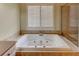 Bathroom featuring jacuzzi tub with neutral color and walk-in shower at 7520 Ledgewood Way, Suwanee, GA 30024