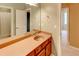 Bathroom vanity with a long mirror, faucet, and wooden cabinet at 7520 Ledgewood Way, Suwanee, GA 30024