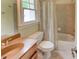 Bathroom showcasing a tub, toilet, shower, and single vanity with a granite countertop at 7520 Ledgewood Way, Suwanee, GA 30024
