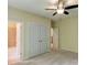 Bedroom with neutral walls and carpet, featuring a ceiling fan and ensuite bathroom at 7520 Ledgewood Way, Suwanee, GA 30024