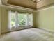 Bright bedroom boasts ample natural light from the large windows and neutral carpeting at 7520 Ledgewood Way, Suwanee, GA 30024