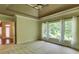 Comfortable bedroom with tray ceiling, large windows, and neutral color palette at 7520 Ledgewood Way, Suwanee, GA 30024