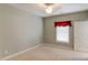 Cozy bedroom with neutral carpet, window with valance, and white door at 7520 Ledgewood Way, Suwanee, GA 30024