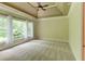 Spacious bedroom features a ceiling fan, tray ceiling, and large windows at 7520 Ledgewood Way, Suwanee, GA 30024