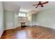 Spacious bonus room features hardwood floors, built-in shelves, and a ceiling fan at 7520 Ledgewood Way, Suwanee, GA 30024