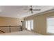 Bonus room featuring ceiling fan, large window, and neutral-colored walls at 7520 Ledgewood Way, Suwanee, GA 30024