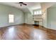 Bonus room with hardwood floors, built-in shelving, and natural light, creating a versatile space at 7520 Ledgewood Way, Suwanee, GA 30024