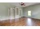 Bonus room with hardwood floors, built-in shelving and plenty of natural light from the window at 7520 Ledgewood Way, Suwanee, GA 30024