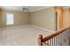 Large bonus room with neutral carpet, natural light, and crown molding at 7520 Ledgewood Way, Suwanee, GA 30024