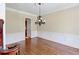 Dining room with hardwood floors, wainscoting and decorative chandelier at 7520 Ledgewood Way, Suwanee, GA 30024