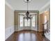 Elegant dining room with hardwood floors, wainscoting, and a decorative chandelier at 7520 Ledgewood Way, Suwanee, GA 30024