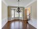 Elegant dining room with hardwood floors, wainscoting, and a decorative chandelier at 7520 Ledgewood Way, Suwanee, GA 30024