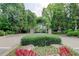 Landscaped neighborhood entrance featuring brick pillars at 7520 Ledgewood Way, Suwanee, GA 30024