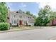 Beautiful two-story home with a welcoming red door, landscaped yard, balcony, and attached two-car garage at 7520 Ledgewood Way, Suwanee, GA 30024