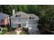 Aerial view of a two-story home with a well-manicured lawn and mature landscaping at 7520 Ledgewood Way, Suwanee, GA 30024
