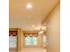 Bright hallway with natural light, neutral paint, and transom windows above doorways at 7520 Ledgewood Way, Suwanee, GA 30024