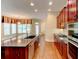 Gourmet kitchen features granite countertops, dark wood cabinets, and stainless steel appliances at 7520 Ledgewood Way, Suwanee, GA 30024