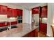 Gourmet kitchen features custom cabinets, granite counters, and stainless appliances at 7520 Ledgewood Way, Suwanee, GA 30024