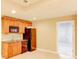 Basement kitchenette with wood cabinets, built-in microwave, sink, and black fridge at 7520 Ledgewood Way, Suwanee, GA 30024