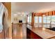 Open-concept layout with hardwood floors, built-in bookshelves, and a cozy fireplace at 7520 Ledgewood Way, Suwanee, GA 30024
