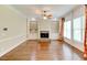 An airy room with hardwood floors, fireplace and built-in shelves at 7520 Ledgewood Way, Suwanee, GA 30024