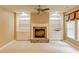 Inviting living room with a stone fireplace, built-in bookshelves, and lots of natural light at 7520 Ledgewood Way, Suwanee, GA 30024