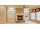 Cozy living room featuring a stone fireplace and built-in bookshelves at 7520 Ledgewood Way, Suwanee, GA 30024
