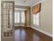 Bright office with hardwood flooring, plantation shutters, crown molding, and charming fabric valances at 7520 Ledgewood Way, Suwanee, GA 30024