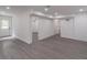 Spacious basement with new gray flooring, white walls, recessed lighting and entry door at 2265 Hillbriar Dr, Buford, GA 30518