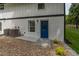 Exterior basement entrance with blue door, brick facade, and decorative rock at 2265 Hillbriar Dr, Buford, GA 30518