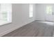 Newly finished basement area features gray flooring, white walls, and natural light from windows and the entry door at 2265 Hillbriar Dr, Buford, GA 30518
