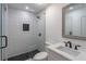 Modern bathroom with glass shower, black fixtures, and mosaic-style tiling at 2265 Hillbriar Dr, Buford, GA 30518