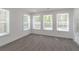 Bright bedroom featuring recessed lights, four windows, and hardwood floors at 2265 Hillbriar Dr, Buford, GA 30518