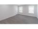 Spacious bedroom featuring windows with natural light and hard wood flooring at 2265 Hillbriar Dr, Buford, GA 30518