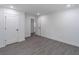 Spacious bedroom with hardwood floors, white walls, and two closet doors at 2265 Hillbriar Dr, Buford, GA 30518