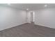 Large bedroom with hardwood floors, white walls, and a door leading to another room at 2265 Hillbriar Dr, Buford, GA 30518