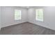 Bright bedroom featuring neutral walls, modern trim and hardwood floors at 2265 Hillbriar Dr, Buford, GA 30518