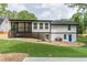 Exterior view of the back of the house, featuring a raised porch and walkout basement at 2265 Hillbriar Dr, Buford, GA 30518