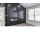 Modern electric fireplace with black shiplap accent wall and recessed lighting at 2265 Hillbriar Dr, Buford, GA 30518