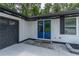 Close up of the front entrance with bright blue double doors and a dark grey garage door at 2265 Hillbriar Dr, Buford, GA 30518