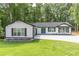 Charming white modern farmhouse with a well manicured lawn and large driveway at 2265 Hillbriar Dr, Buford, GA 30518
